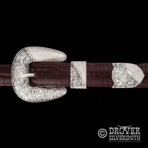 The Wrangler Sterling Silver Belt Buckle Set combines a traditional hand engraved base with crossgrain texture for a sophisticated Western touch! Add a second loop for a ranger buckle set now!
